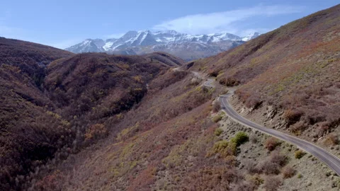 Mountain Road with Snow-capped mountain background - Drone Stock-Footage 170903719