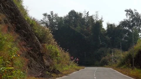 Mountain Road With Speed Limit and Warning Signs Stock Footage 329840053