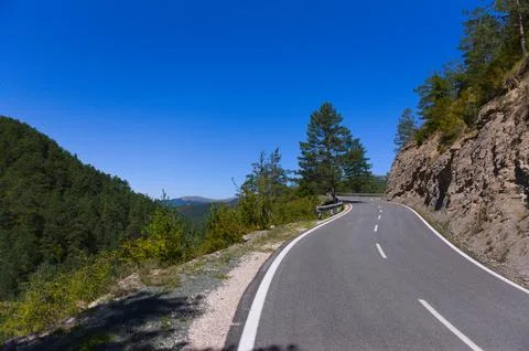 Mountain road surrounded by forest Foto stock
