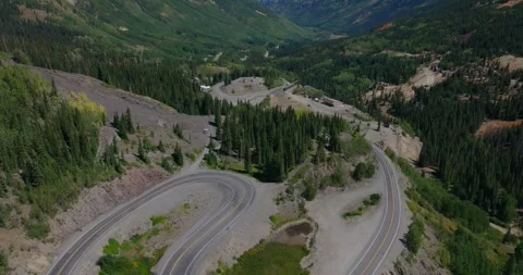 Mountain Road Through Forested Alpine Slopes and Valleys Stock Footage 330900545