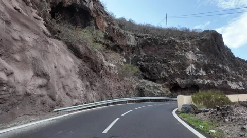 Mountain Road Through Rocky Volcanic Cliffs and Rugged Landscape Vídeos de archivo 330010093