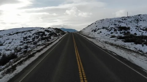 Mountain Road tilt up from road to mountain aerial shot. Stock Footage