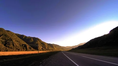 Mountain road timelapse at the summer or autumn sunset sunrise time. Wild nature Stock Footage 94237825