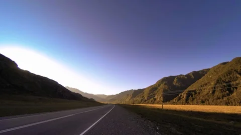 Mountain road timelapse at the summer or autumn sunset sunrise time. Wild nature Stock Footage 116396357