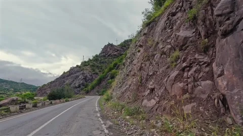 Mountain road trip curves through a steep rocky corridor Stock Footage 343805057