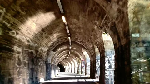 Mountain Road in a Tunnel with Sunlight 動画素材 165201340