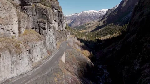 Mountain road under snow capped mountain 動画素材 305701907