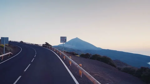 Mountain road with a view of the volcano Teide after sunset Stock Footage 100331392