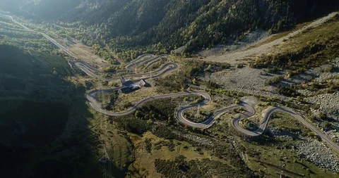 Mountain road winds up steep valley drone aerial 4k Stock Footage 125757921