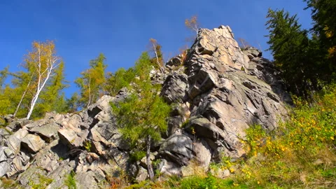 Mountain rocks, trees landscape on blue sky. Calm natural scene. Stock Footage 253216573