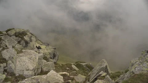 Mountain Rocks Vapor and Clouds Rising 4K Stock Footage 64220421