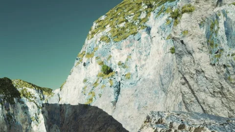 Mountain rocky surface with green grass in daylight Stock Footage 339873188