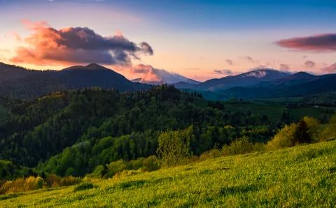 Mountain rural area in springtime at cloudy sunset Stock Photos