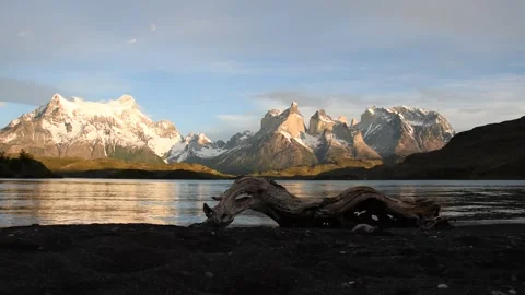 Mountain scenery with gentle waves lapping on the shore at Torres del Paine Stock Footage 133814443