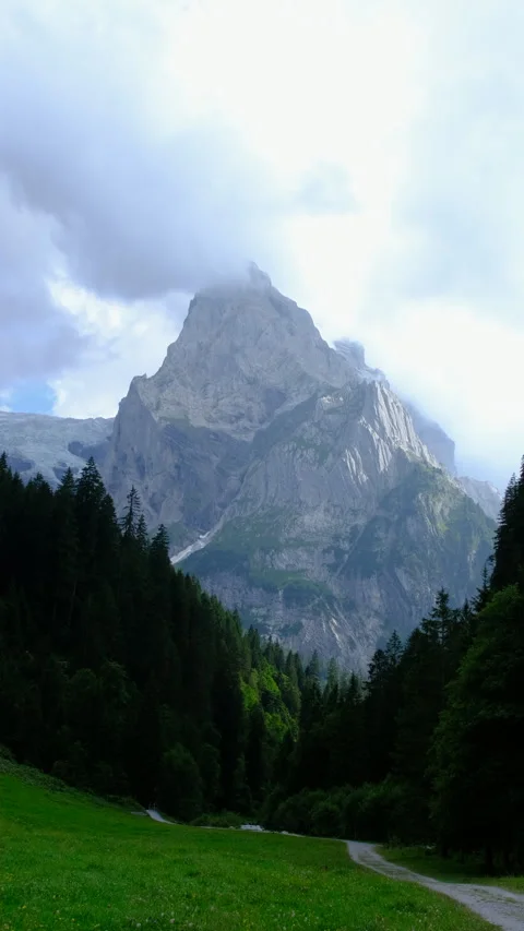 Mountain scree peak in low clouds and river at the foot. climbing concept Stock Footage 284616179