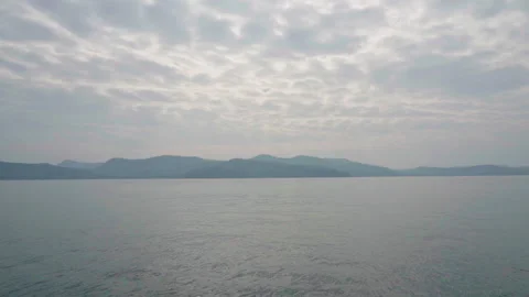 Mountain from the sea view with cloudy sky shot on boat slow motion Video stock 159330273