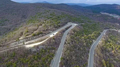 Mountain serpentine road through the forest, aerial view Stock Footage 72711325