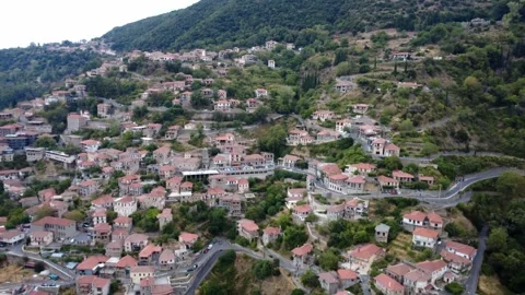 Mountain settlement with stone architecture surrounded by greenery in Greece Video stock 321892697