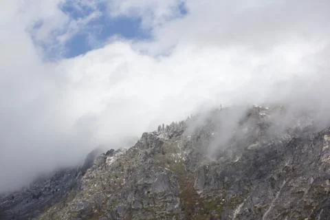 Mountain side with clouds rolling in Stock Photos