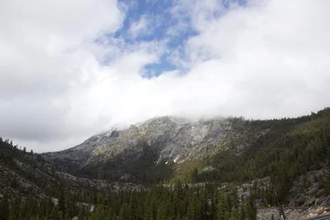 Mountain side with clouds rolling in Stock Photos