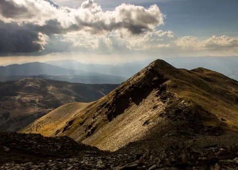 Mountain Side Sunlit by Sun Rays in the Pyrenees Stock Photos