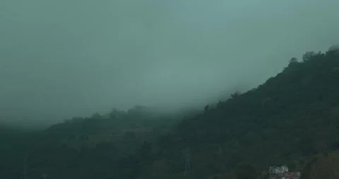 Mountain side of a tropical forest with clouds and fog 스톡 동영상 242166830