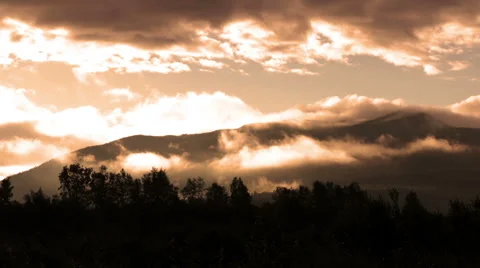 Mountain silhouette and clouds in the early morning sun Stock Footage 67355063