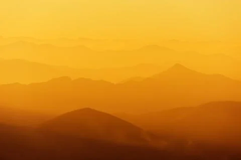Mountain silhouettes at sunset Stock Photos