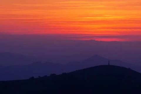 Mountain silhouettes at sunset Stock Photos