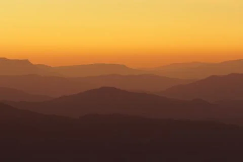 Mountain silhouettes at sunset Stock Photos