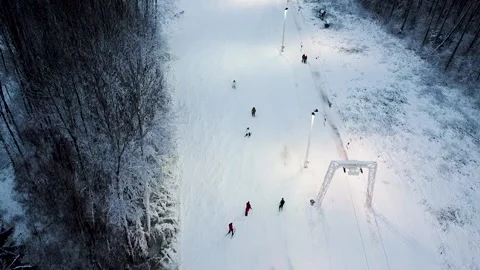 Mountain skiers going downhill next to a lift in Kuutsemäe in Estonia Stock Footage 169391460