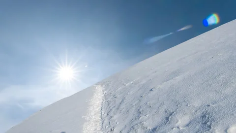 Mountain slope covered by a snow in a light of sparkle sun Stock-Footage 332800010