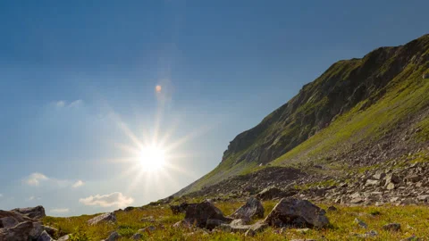 Mountain slope in a rays of sun time lapse scene Stock Footage 178896999