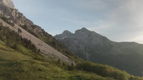Mountain Slope with Rocky Cliffs and Green Hillside Stock Footage 289667362