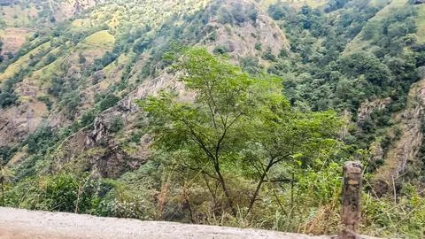 Mountain slopes beyond the road. Stock Photos
