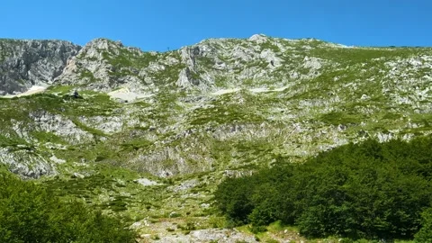 Mountain slopes rise under clear blue skies. Savin Kuk peak, Montenegro Видео 342982747