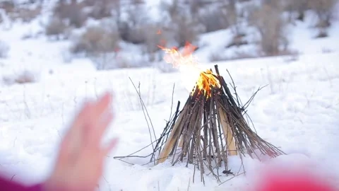 Mountain snow close-up campfire hands warming children (close-up) Video stock 145654487