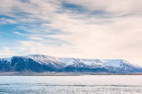 Mountain with snow in the ocean Stock Photos