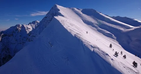 Mountain snow ridge panning to orbit view Stock Footage 93456575