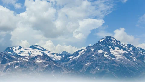 Mountain in a snow under a dense cloudy sky, time lapse scene Stock Footage 148837876