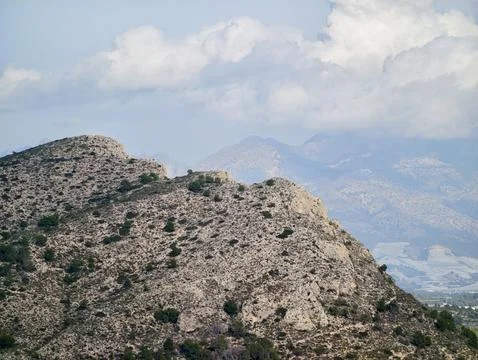 Mountain solitude scene, Desolate rugged summit with distant foggy mountain.. Фото