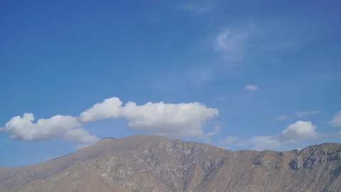 Mountain with some cloud on the blue clear sky Stock Photos