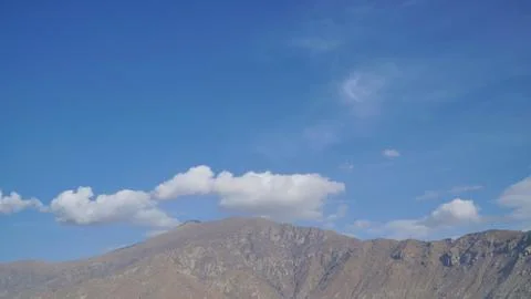 Mountain with some cloud on the blue clear sky Stock Photos