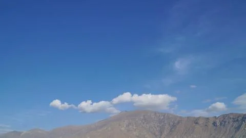 Mountain with some cloud on the blue clear sky Stock Photos