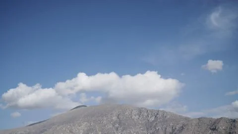 Mountain with some cloud on the blue clear sky Stock Photos