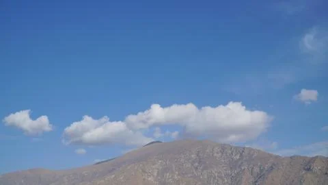 Mountain with some cloud on the blue clear sky Stock Photos