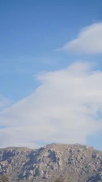 Mountain with some cloud on the blue clear sky Stock Photos