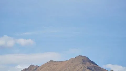 Mountain with some cloud on the blue clear sky Stock Photos