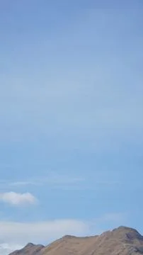 Mountain with some cloud on the blue clear sky Stock Photos