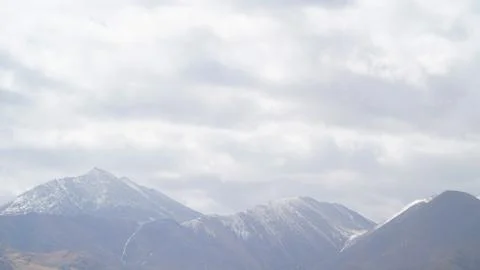 Mountain with some cloud on the blue clear sky Stock Photos